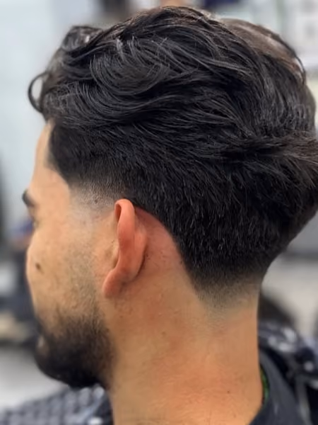 Wavy Blowout Taper & Natural Neckline - High-volume wavy layered blowout with graduated low temple and neck taper contour.